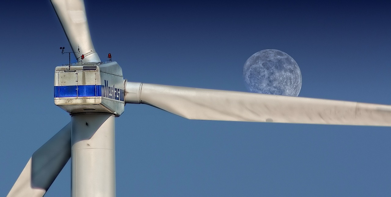 Wind turbine with moon in background